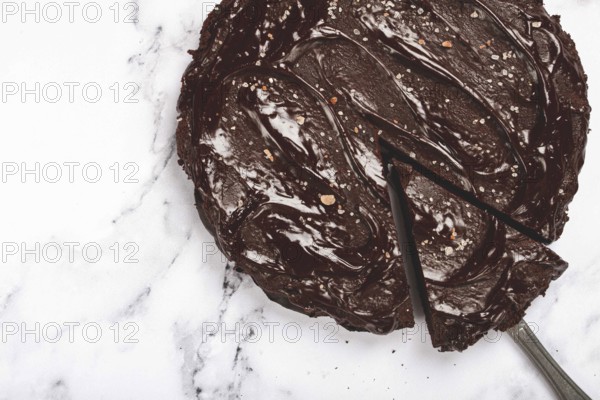 Chocolate cake, round cake, on a marble light table, top view, homemade cakes, no people