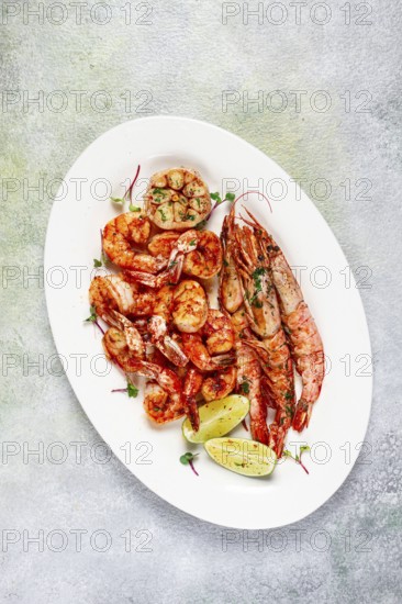 Fried langoustines and tiger shrimps, with spices and herbs, homemade dish, without people