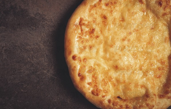 Khachapuri in Megrelian, a traditional Georgian dish, flatbread with cheese, top view, no people