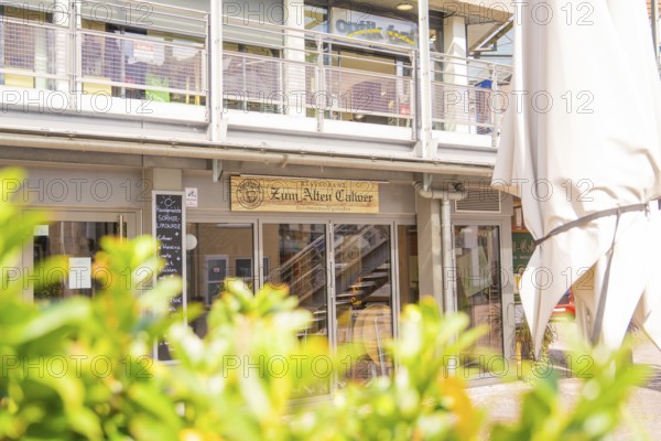 Modern building with restaurant on the ground floor and urban atmosphere, small town pearl Calw, Black Forest, Germany