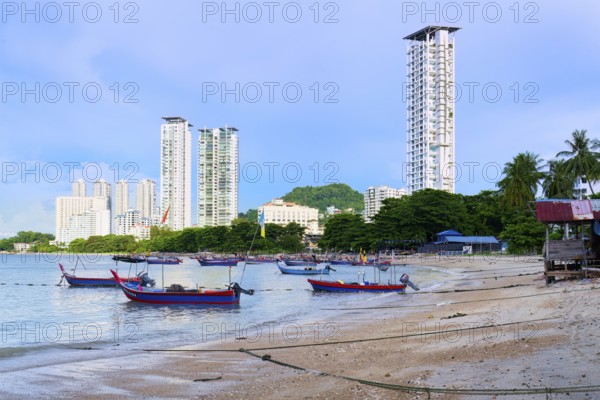 Fishing boats and George Town skyline along the Malacca Strait near Penang Floating Mosque, Penang, Malaisia