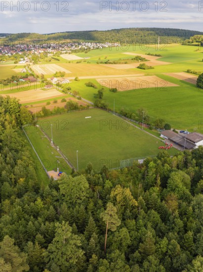 Sports ground surrounded by fields and forest near a housing estate, VFL Stammheim, Calw, Black Forest, Germany