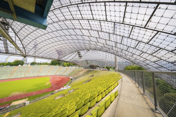 Walk along empty stands in the stadium with a view of a wide playing field, Olympiapark, Munich, Germany