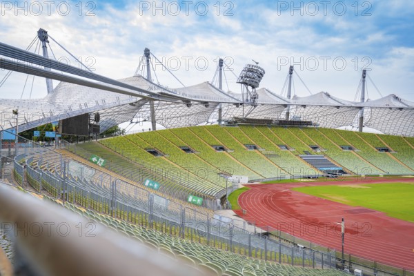 Exterior view of the stadium with striking tent structure and red running track, Olympic Park, Munich, Germany