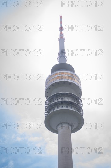 Architecturally striking television tower with spiral structure in front of a cloudy sky, Olympic Park, Munich, Germany