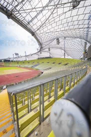Close-up in the stadium with empty seats and striking roof construction, Olympiapark, Munich, Germany