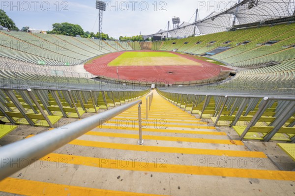 Central view of the stadium from the stairs onto empty stands and red running track, Olympic Park, Munich, Germany