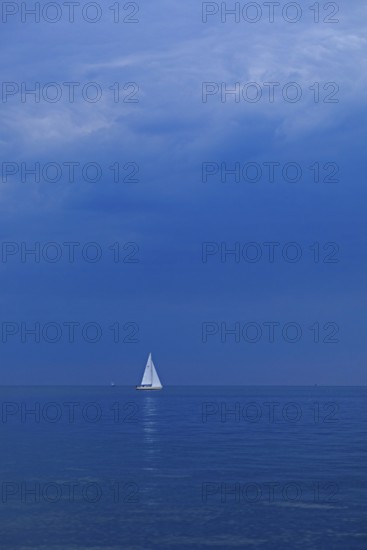 Sailboat off Falckenstein, dark clouds, Kiel Fjord, Kiel, Schleswig-Holstein, Germany