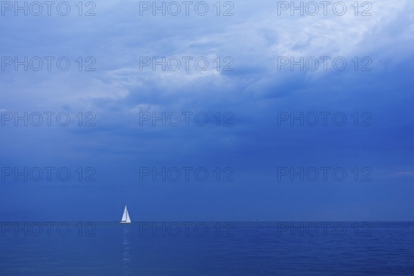 Sailboat off Falckenstein, dark clouds, Kiel Fjord, Kiel, Schleswig-Holstein, Germany