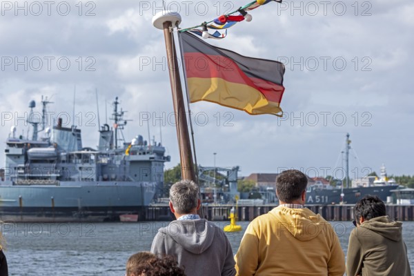 Toruists on excursion boat, flag, Bundeswehr ships, naval base, Kiel, Schleswig-Holstein, Germany