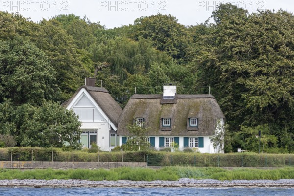 Thatched-roof houses on the shore, Kiel Fjord, Schleswig-Holstein, Germany
