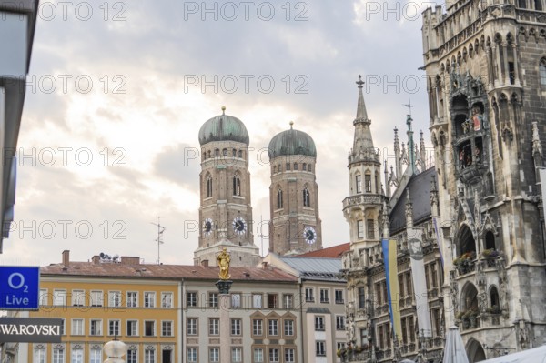 City view with historic buildings and church towers under a cloudy sky, Munich, Germany