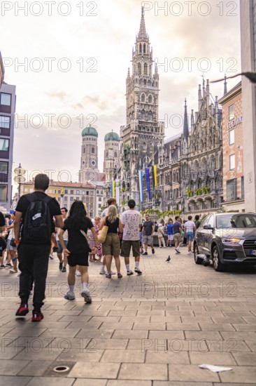 Lively street scene on Marienplatz with striking building towers, Marienplatz, Munich, Germany