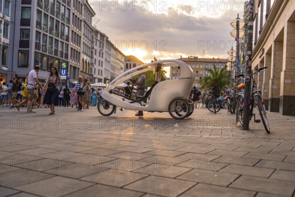 Bicycle taxi in Munich city centre at sunset, Munich, Germany