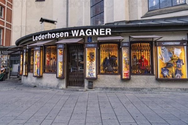 Illuminated shop window of a traditional lederhosen shop, Munich, Germany
