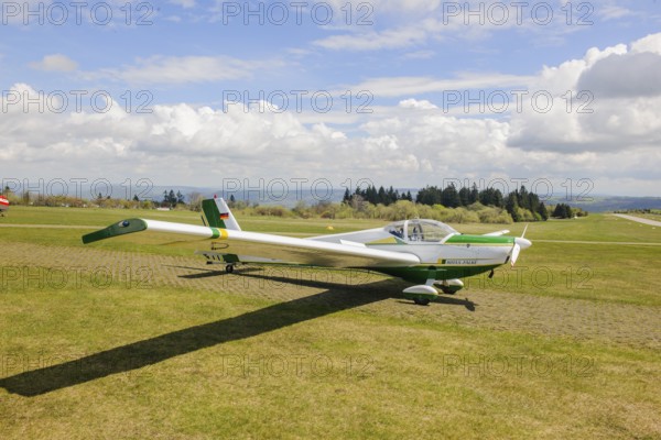 Motor glider of type Scheibe SF.25C Falke is parked at Wasserkuppe airfield, Wasserkuppe airfield, Rhön, Gersfeld, district of Fulda, Hesse, Germany