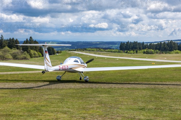 Motorised glider taxiing to the runway at Wasserkuppe airfield, Rhön, Gersfeld, Fulda district, Hesse, Germany