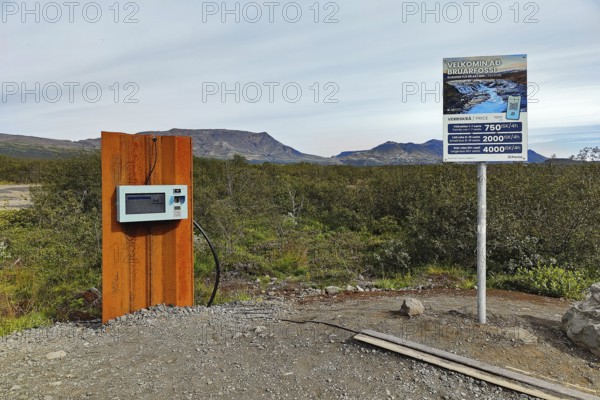 Car park at Brúarfoss waterfall with EC machines for paying in the countryside, South Iceland, Iceland