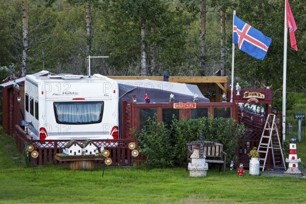 Icelandic permanent camper with full decoration and Icelandic flag at the campsite in Uthlid in Biskupstungur, Iceland