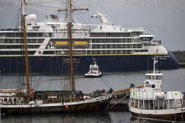 A cruise ship, a sailing ship and other ships and boats in the harbour, Husavik, Iceland