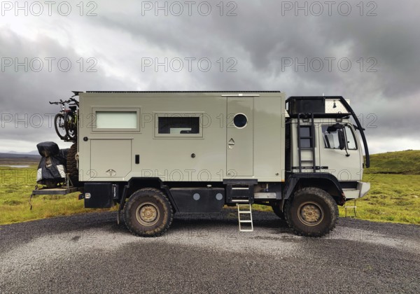 Large camping vehicle parked in a car park on the Kaldidalur slope, Highlands, Iceland