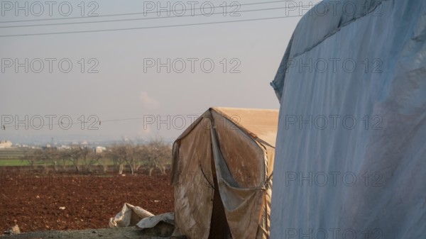 Worn-out tents housing Syrian refugees near the Turkish border, showing the dire humanitarian conditions in which displaced people are forced to live. Aleppo, Syria. January 26, 2023, Aleppo, Syria