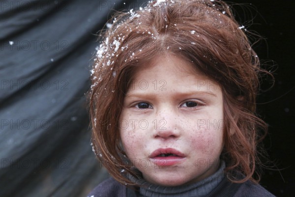 Displaced Syrian families and children living in refugee camps during harsh winter conditions, facing snow, cold weather, and difficult humanitarian circumstances. Aleppo, Syria March 13, 2022, Aleppo, Syria