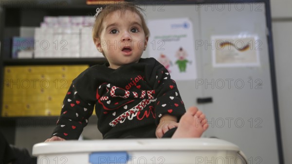 A doctor examining a refugee child for malnutrition in the camp using weight and height measurement. Aleppo, Syria October 18, 2022, Aleppo, Syria