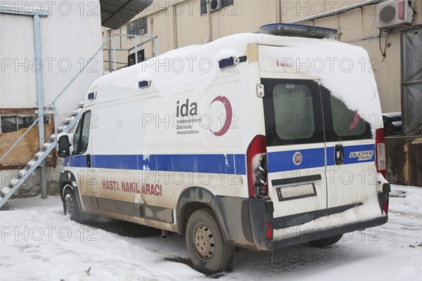 An ambulance parked at the entrance of an informal refugee camp, prepared for any medical intervention to assist displaced Syrians. Aleppo, Syria. January 23, 2022 – 00:00:00, Aleppo, Syria