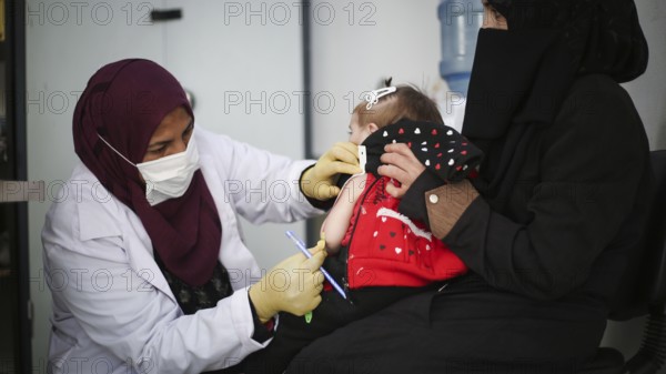 A doctor examines children's malnutrition inside a refugee camp. Malnutrition was measured using a mid-upper arm circumference belt. Aleppo, Syria October 29, 2022, Aleppo, Syria
