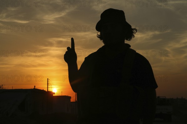 Silhouette of a Syrian armed opposition fighter at sunset, during the war against the PKK. Aleppo, Syria October 10, 2016, Aleppo, Syria