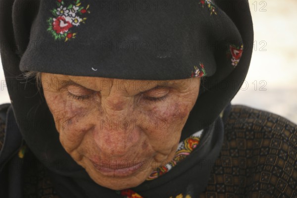 An elderly Syrian refugee looks worn out by war, as displaced people endure difficult conditions in camps. Aleppo, Syria August 29, 2016, Aleppo, Syria