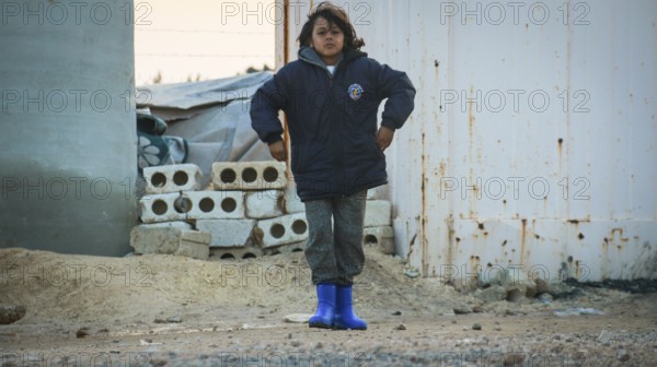 A Syrian refugee child photographed in a camp, reflecting the harsh living conditions of displaced families. Aleppo, Syria April 17, 2016, Aleppo, Syria