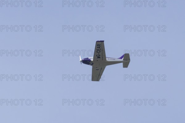 Alpi Pioneer 300 light aircraft flying in a blue sky, England, United Kingdom