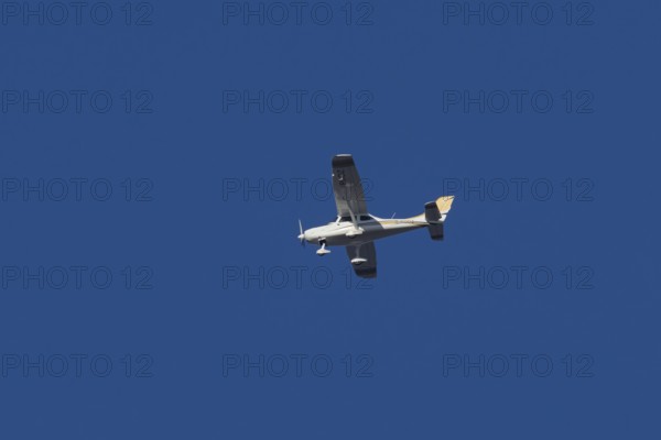 TL Ultralight Sirius 600 light aircraft flying in a blue sky, England, United Kingdom