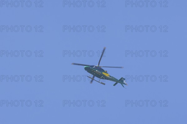 Agusta AW119 Koala Mk.II helicopter flying in a blue sky, England, United Kingdom