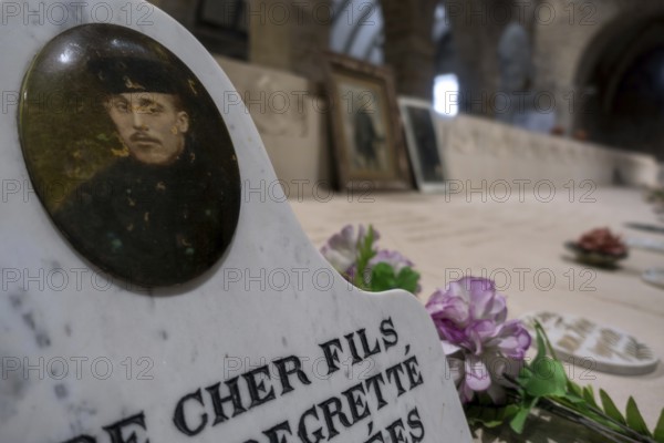 WWI soldier's portrait at necropolis with graves of Belgian World War One soldiers buried in the church of Grimde near Tienen, Tirlemont, Belgium