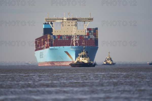Container ship with pilot vessels near Bremerhaven, Lower Saxony