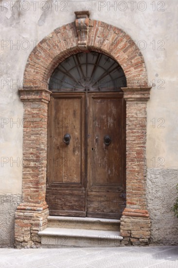 Old wooden entrance door, Montalcino, Province of Siena, Tuscany, Italy