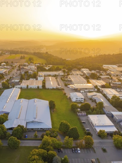 Industrial area with many buildings in a picturesque landscape at sunset, industrial area Wolfsberg Nagold, district Calw, Black Forest, Germany