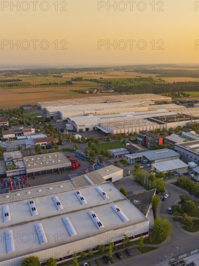 Industrial buildings and roads near fields with vehicles and urban development, Wolfsberg Nagold industrial area, Calw district, Black Forest, Germany
