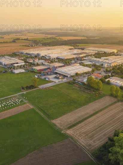 Industrial area with surrounding fields at sunset, industrial area Wolfsberg Nagold, district Calw, Black Forest, Germany