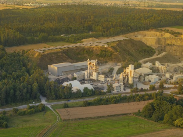 Aerial view of a factory surrounded by forests and fields in daylight, Wolfsberg Nagold industrial area, Calw district, Black Forest, Germany