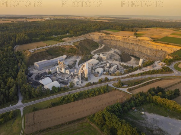 Large quarry and industrial area in a rural setting in the evening, industrial area Wolfsberg Nagold, district Calw, Black Forest, Germany