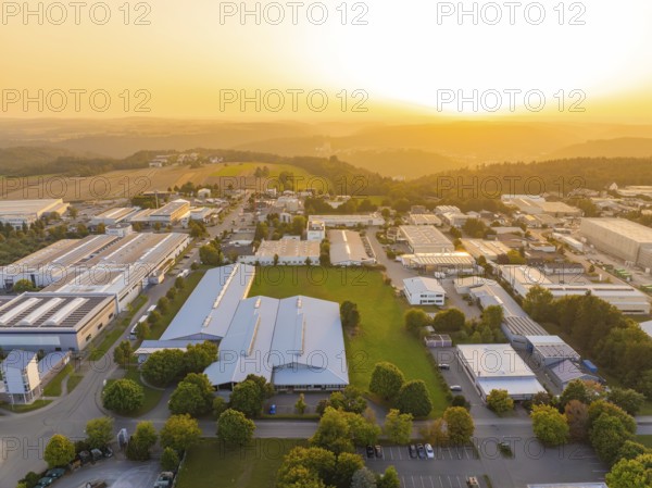 Industrial complex with surrounding green areas and fields at sunset, industrial area Wolfsberg Nagold, district Calw, Black Forest, Germany