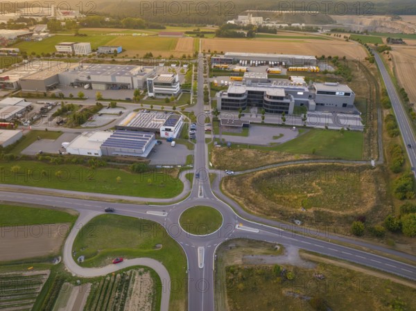 Industrial area with central roundabout, adjacent to fields and modern buildings, industrial area Wolfsberg Nagold, district of Calw, Black Forest, Germany