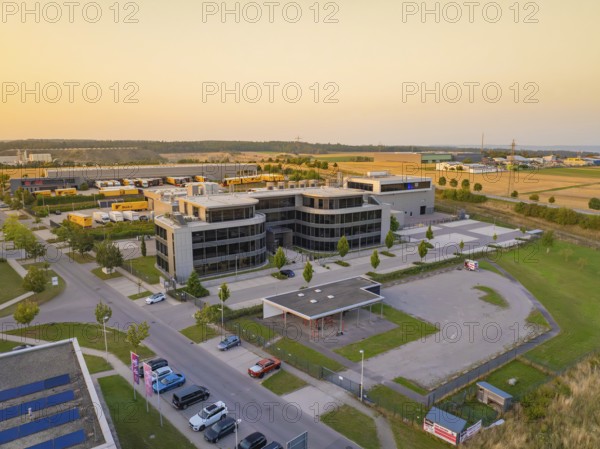 Modern office buildings and car parks in an urban setting at sunset, Wolfsberg Nagold industrial area, Calw district, Black Forest, Germany