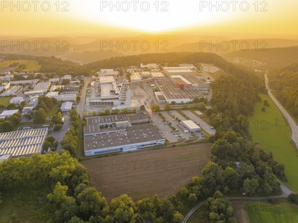 Industrial area with neighbouring forest and country road at sunset, industrial area Wolfsberg Nagold, district Calw, Black Forest, Germany