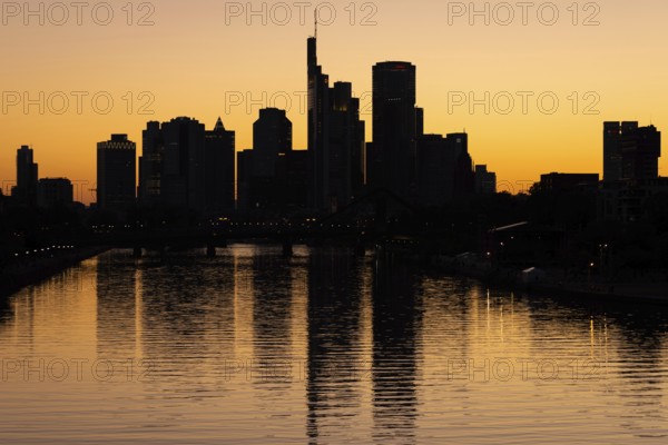 The sun sets behind the Frankfurt banking skyline, Frankfurt am Main, Hesse, Germany