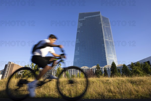 A cyclist rides past the European Central Bank (ECB) in Frankfurt am Main, Frankfurt am Main, Hesse, Germany